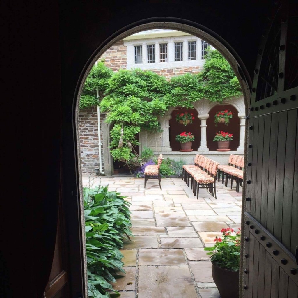 View from a doorway onto a courtyard with rows of chairs